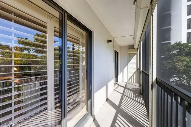 a view of a balcony with wooden floor and fence