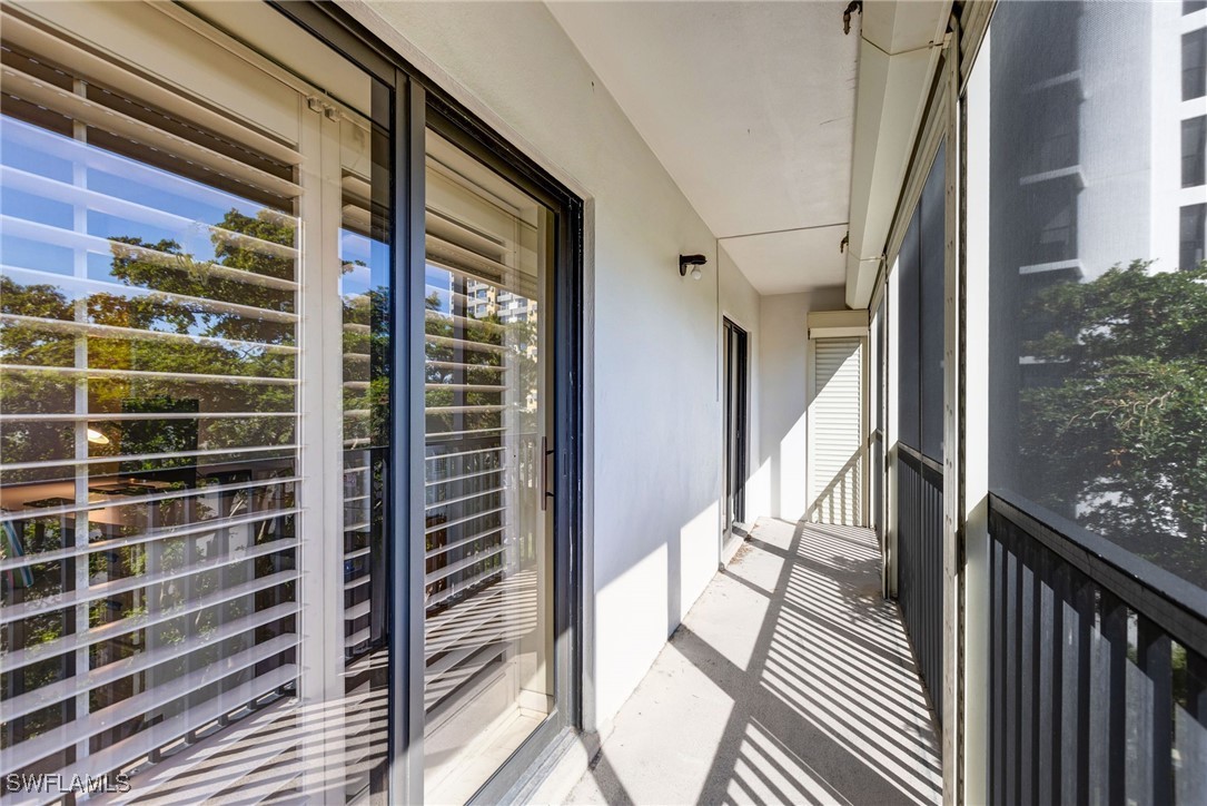 1910 Virginia Avenue, Unit 403 Fort Myers, FL 33901 - Photo 30 of 45 a view of a balcony with wooden floor and fence
