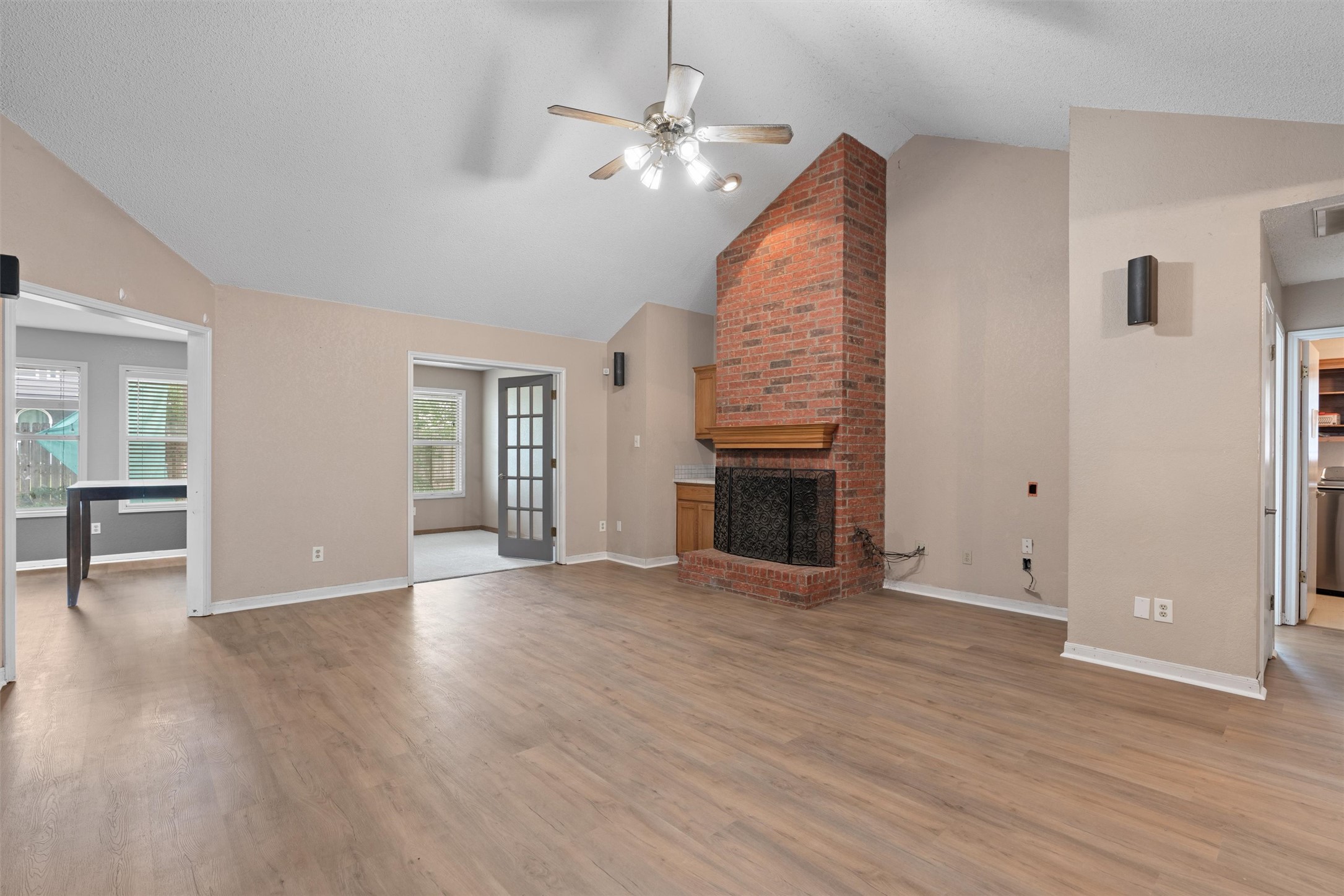 2306 Raintree Path Round Rock, TX 78664 - Photo 5 of 23 A striking brick fireplace accents this spacious living area with warm wood-tone flooring.