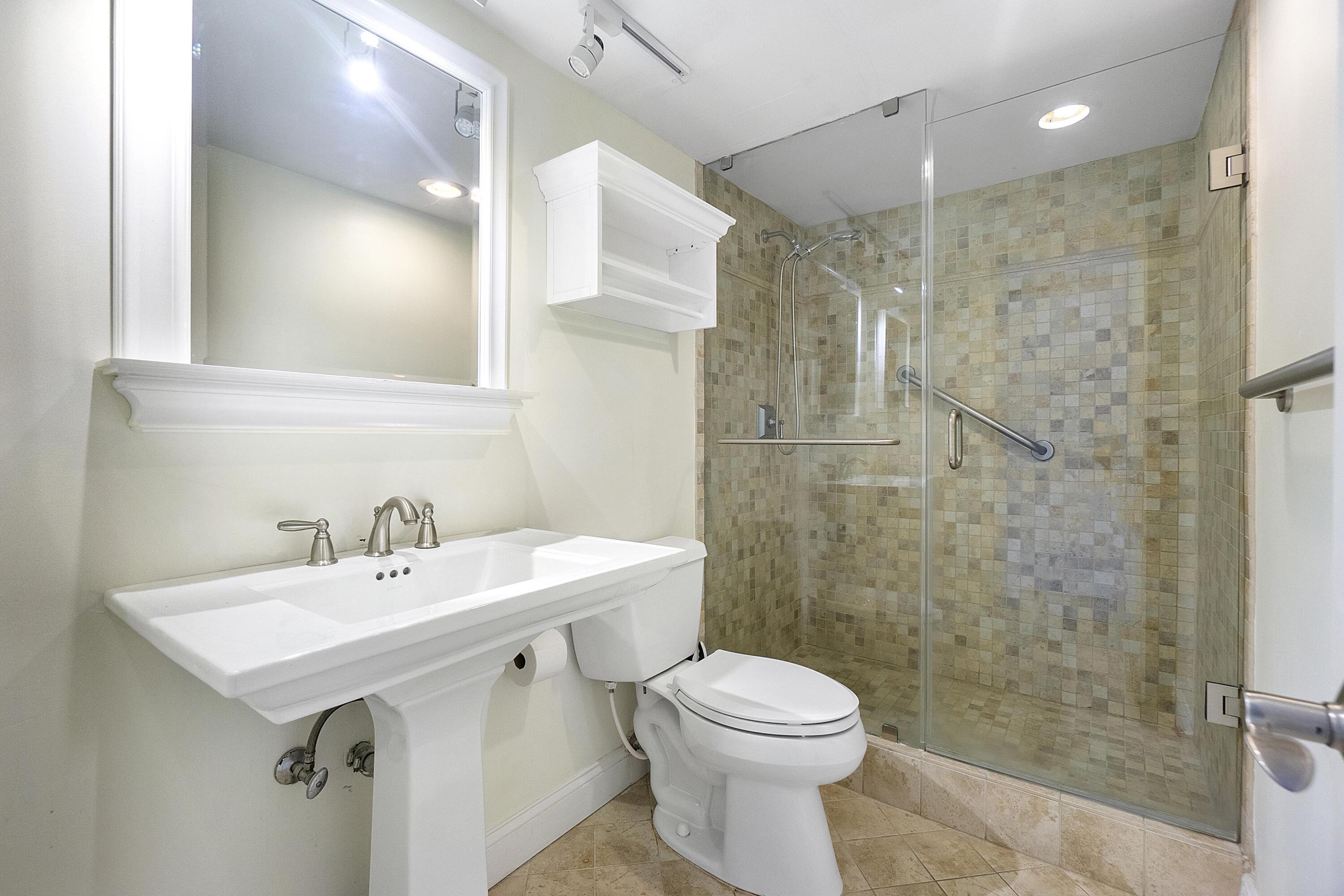 3000 South Ocean Boulevard, Unit 304 Boca Raton, FL 33432 - Photo 14 of 41 a bathroom with a sink mirror toilet and shower