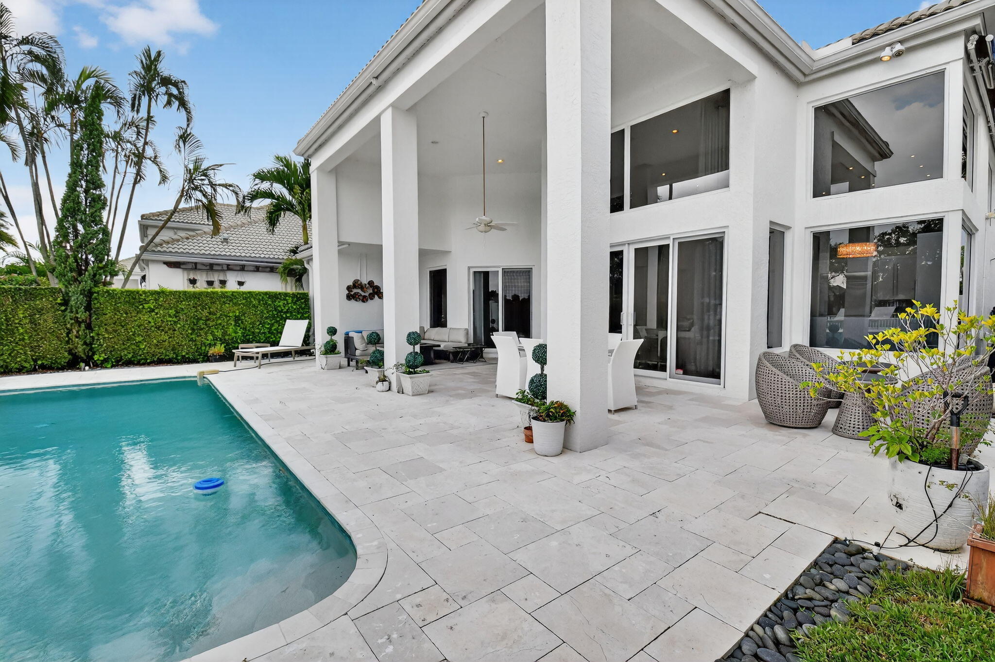 2563 Northwest 63rd Street Boca Raton, FL 33496 - Photo 43 of 65 a view of a house with sitting area and garden
