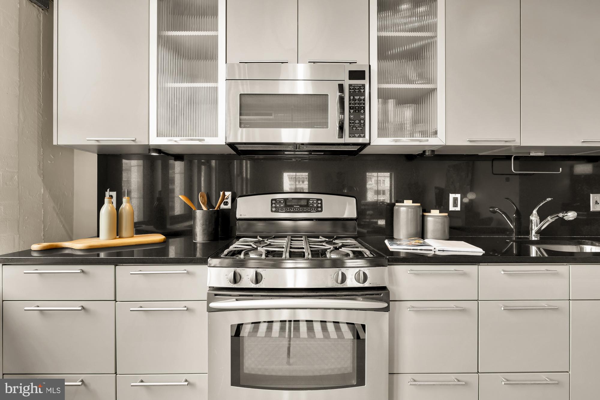 916 G St. Northwest, Unit 806 Washington, DC 20001 - Photo 9 of 19 a stove top oven sitting inside of a kitchen