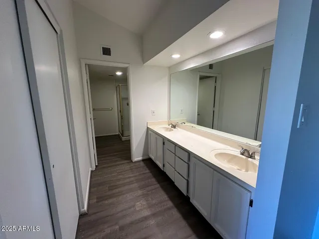 a bathroom with a double vanity sink and a mirror