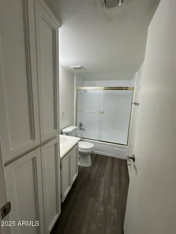a bathroom with a double vanity sink toilet and shower