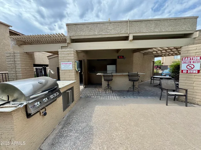an outdoor living area with furniture