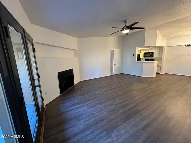 wooden floor in an empty room with a fireplace