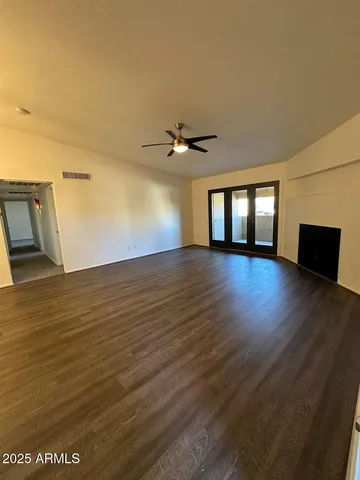 wooden floor in an empty room with a window
