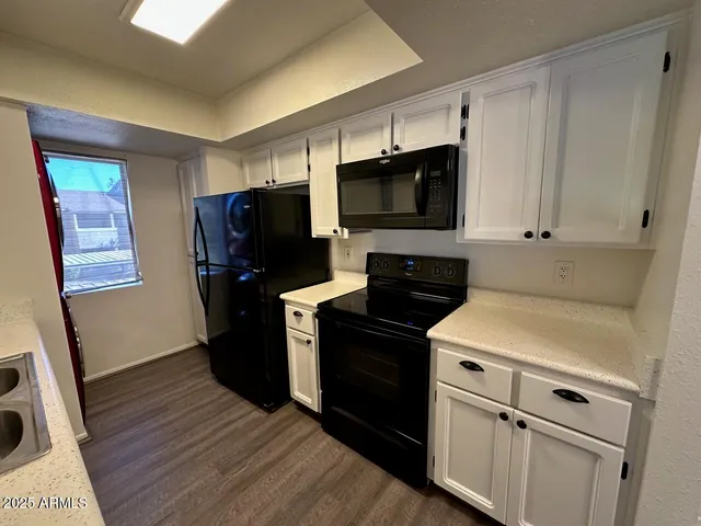 a kitchen with a refrigerator stove and microwave