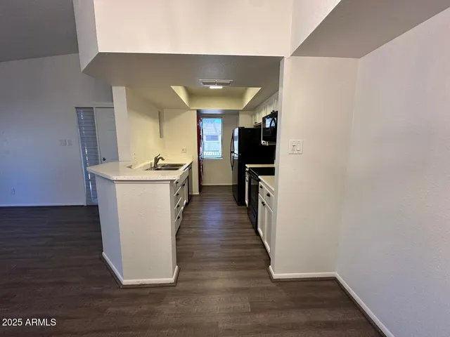 a view of a kitchen from the hallway