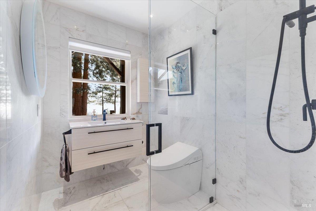 3100 Muniz Ranch Road Jenner, CA 95450 - Photo 7 of 62 a bathroom with a toilet sink and mirror