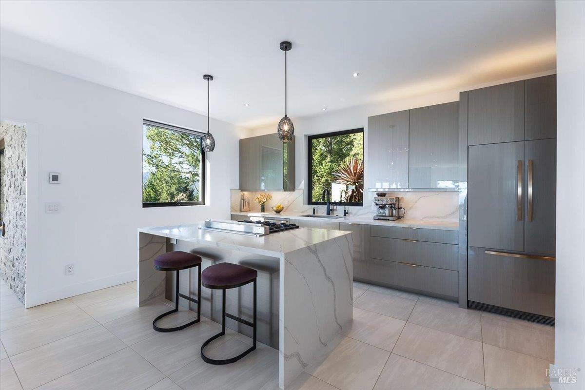 3100 Muniz Ranch Road Jenner, CA 95450 - Photo 8 of 62 Custom Cabinetry with under cabinet lighting and decorative Studio Bel Vetro lighting fixture