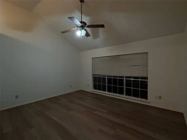 a view of wooden floor wooden cabinets and windows in a room