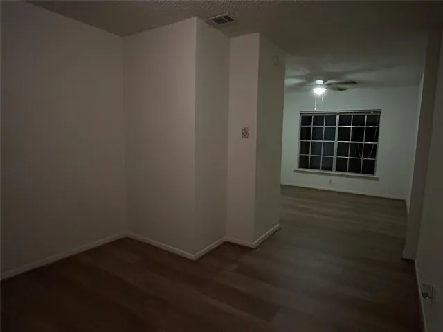 a view of a livingroom with wooden floor and window