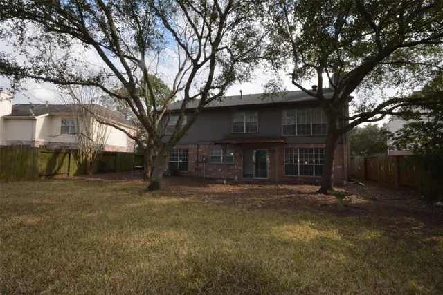 a view of a house with a large tree