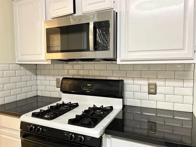 a kitchen with a stove and a microwave