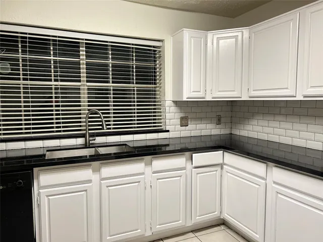 a kitchen with a sink and cabinets