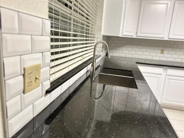 a kitchen with a sink and cabinets