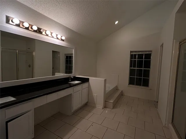 a kitchen with granite countertop a stove and cabinets