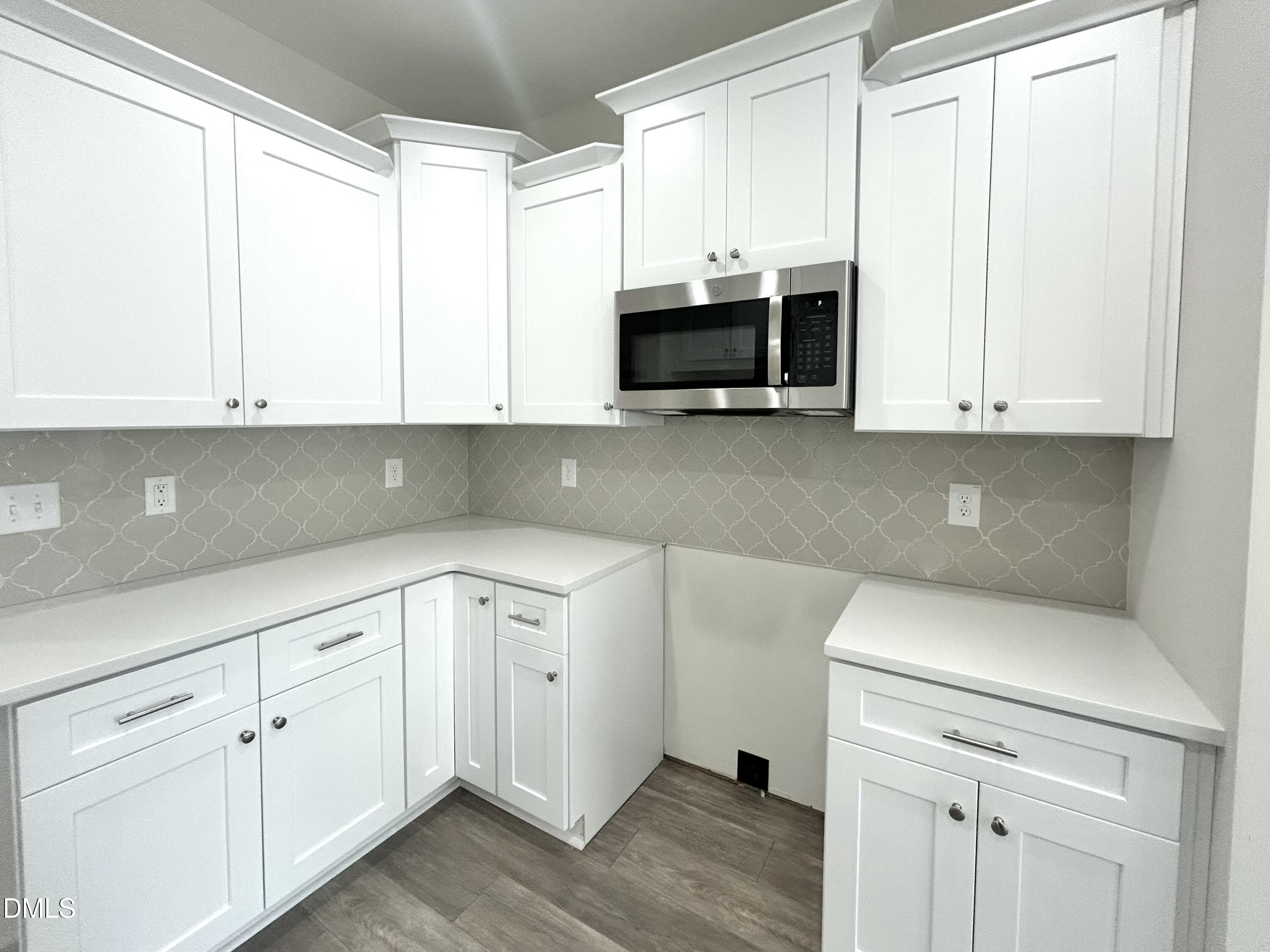 1725 Cardinal Drive Deep Run, NC 28525 - Photo 11 of 21 a kitchen with stainless steel appliances granite countertop white cabinets sink and a granite counter top