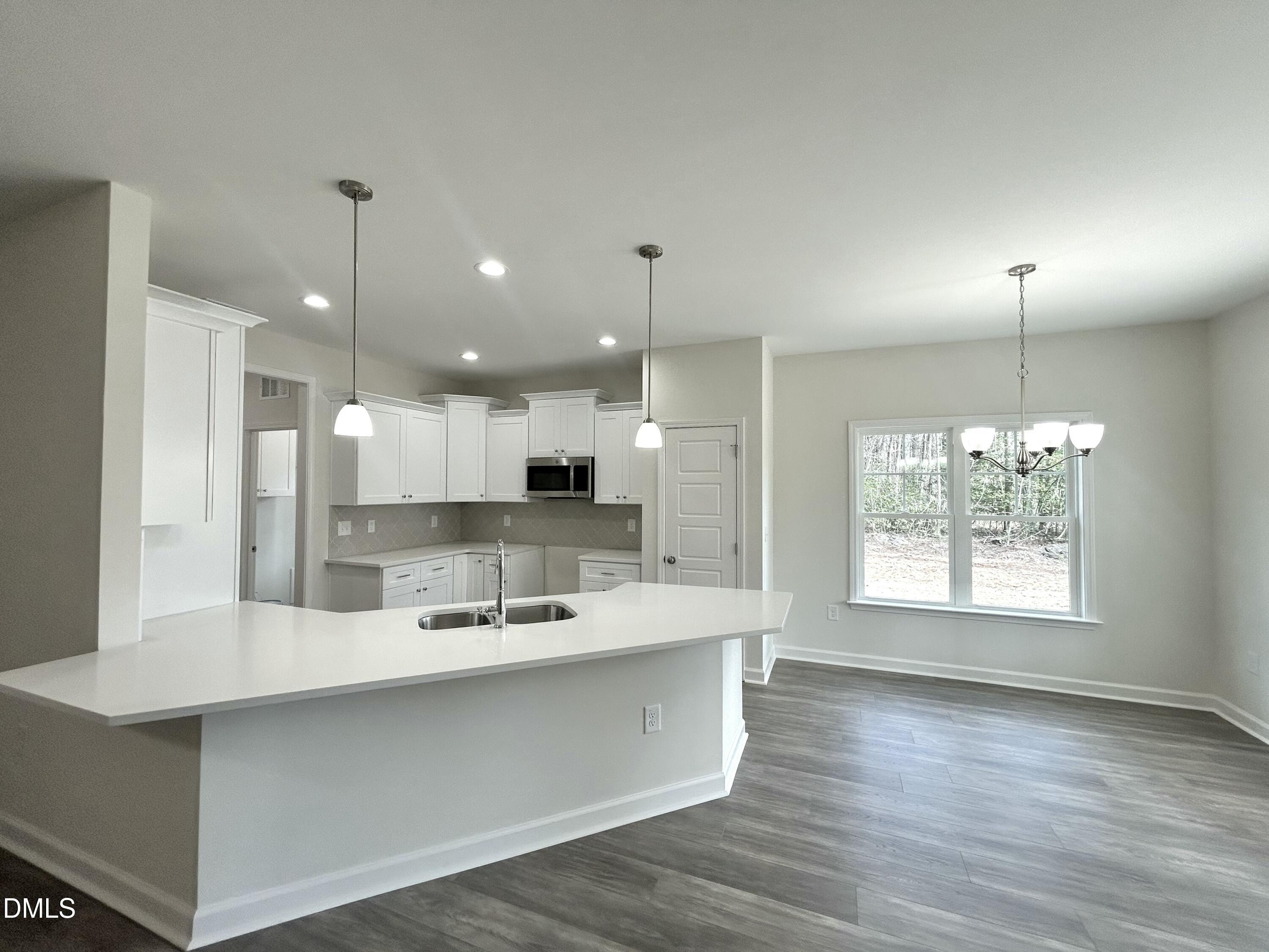 1725 Cardinal Drive Deep Run, NC 28525 - Photo 4 of 21 a large kitchen with kitchen island a sink stainless steel appliances and a window