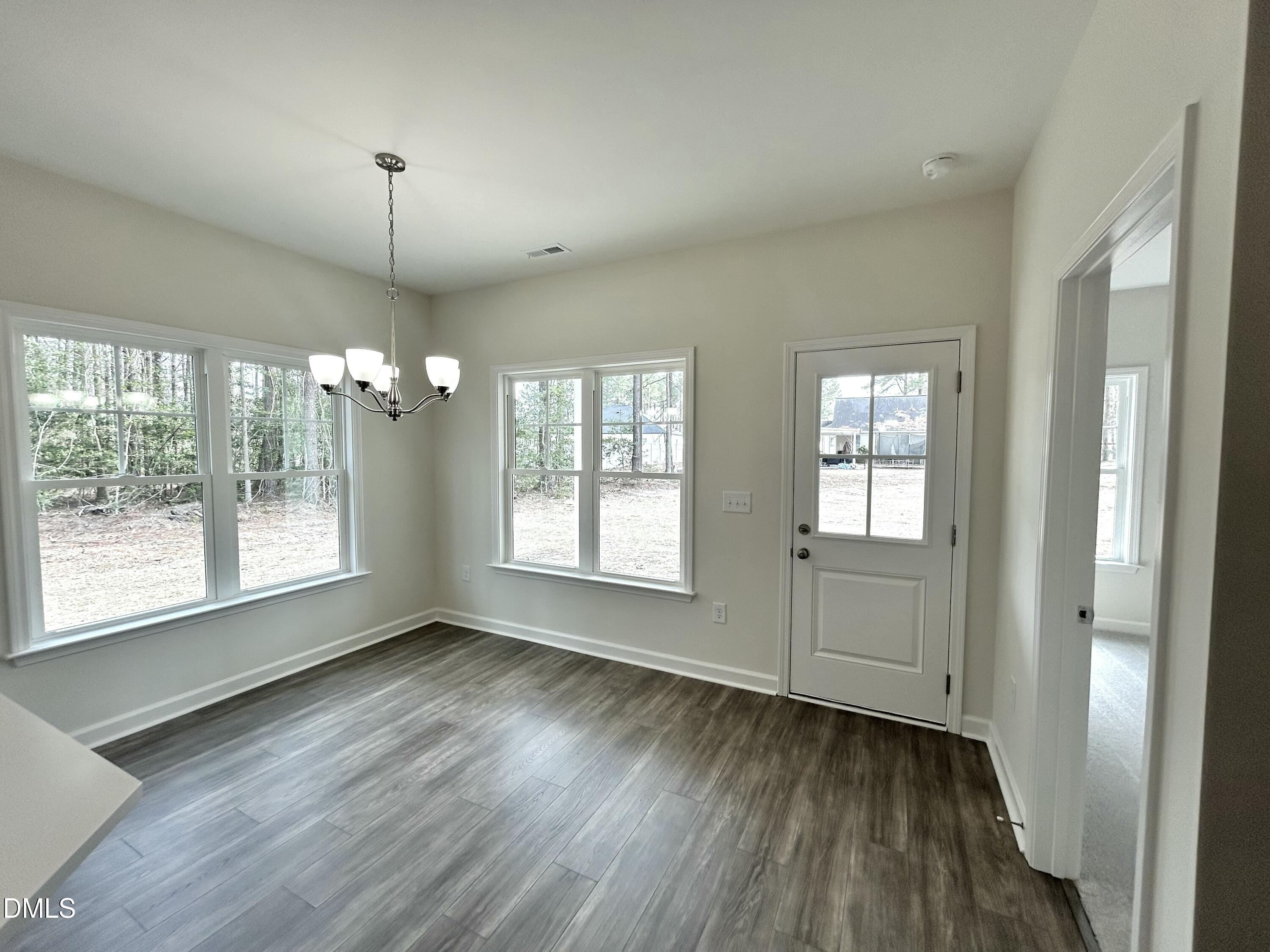 1725 Cardinal Drive Deep Run, NC 28525 - Photo 5 of 21 an empty room with wooden floor and windows