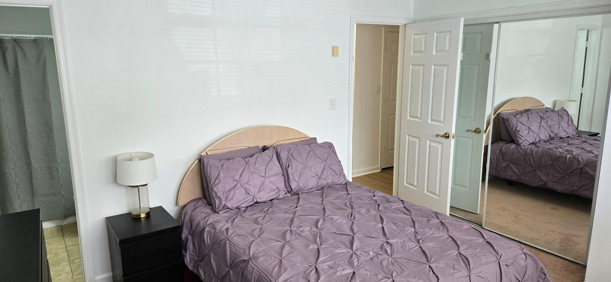 4218 Applegate Lane, Unit 9 Suitland, MD 20746 - Photo 12 of 35 a bedroom with a bed a couch and a large mirror