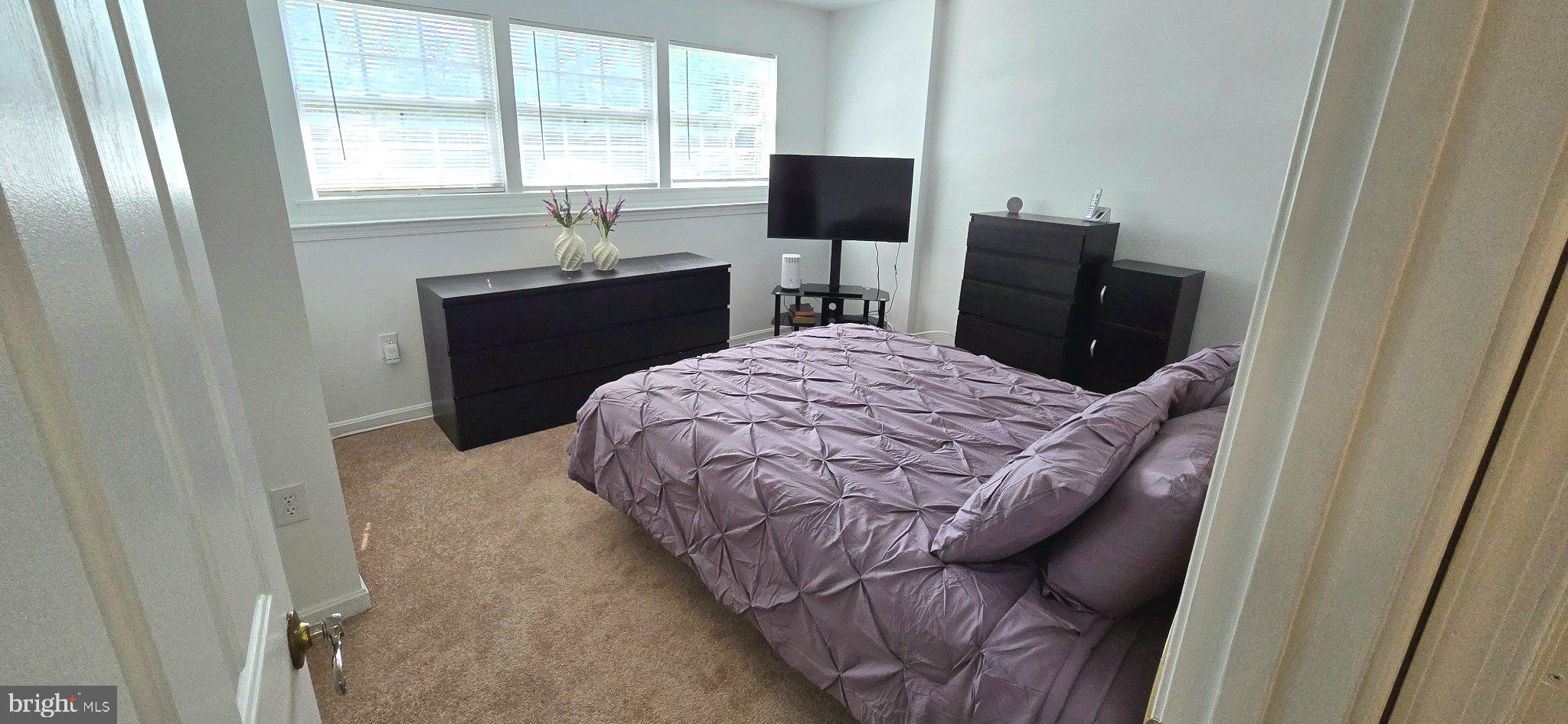 4218 Applegate Lane, Unit 9 Suitland, MD 20746 - Photo 13 of 35 a bedroom with a bed and a desk next to a window