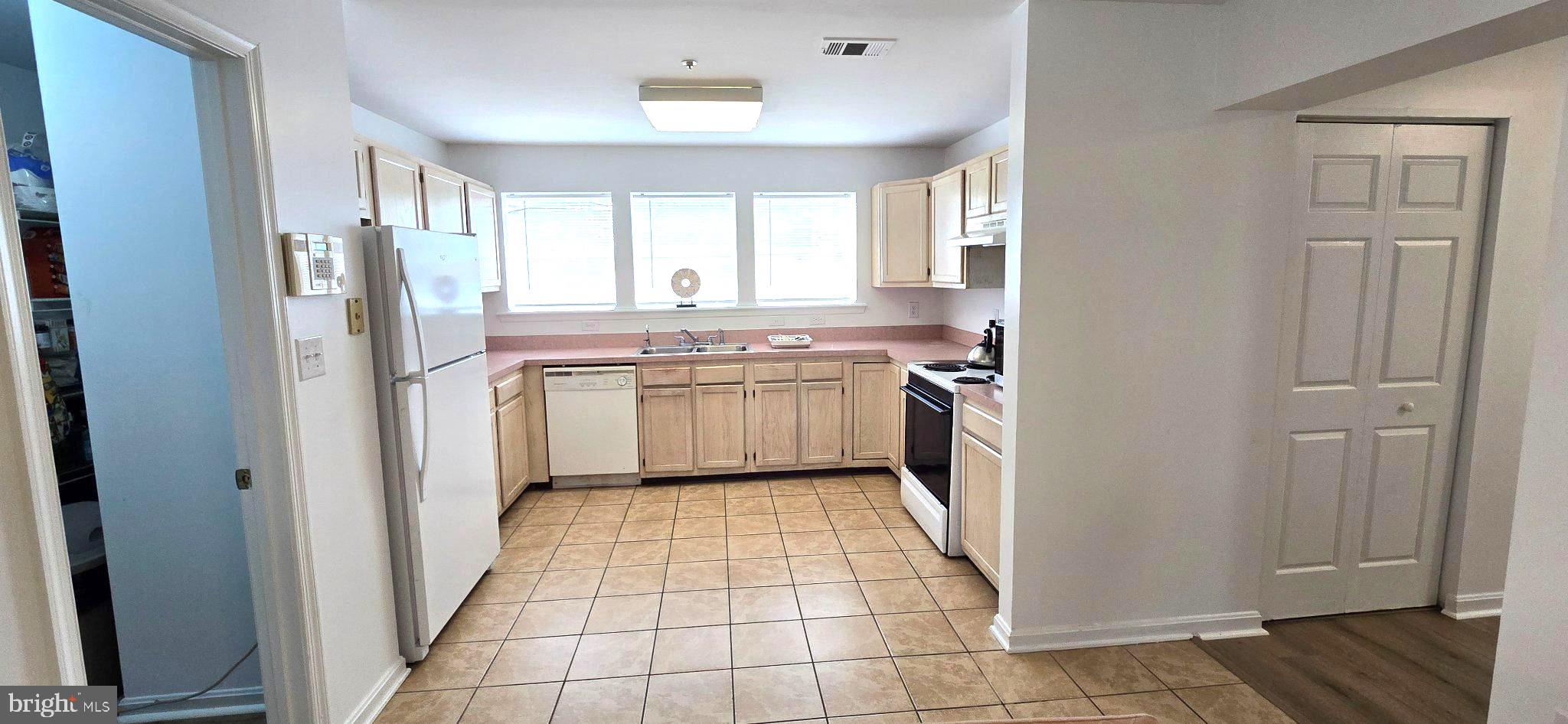 4218 Applegate Lane, Unit 9 Suitland, MD 20746 - Photo 7 of 35 a kitchen with stainless steel appliances granite countertop a refrigerator and a sink