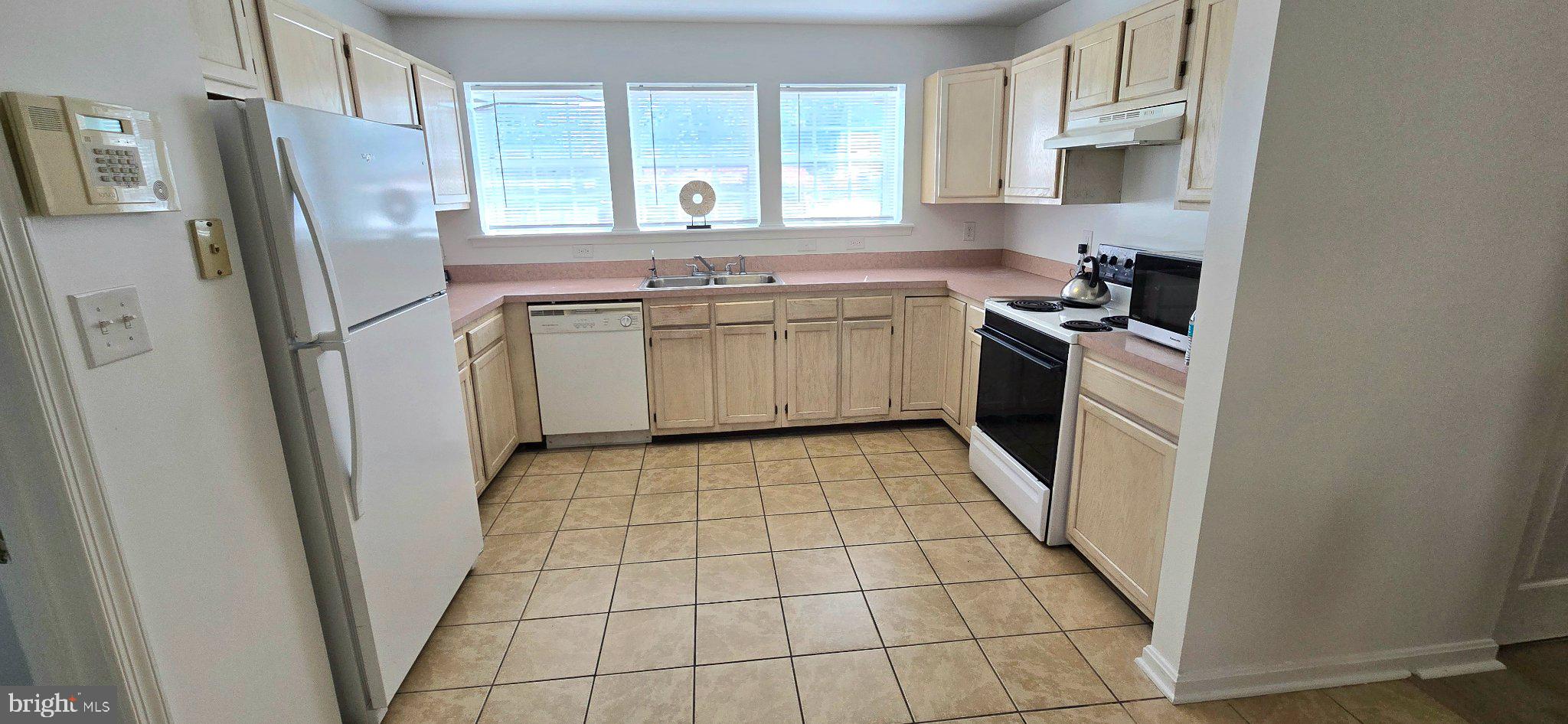 4218 Applegate Lane, Unit 9 Suitland, MD 20746 - Photo 8 of 35 a kitchen with a stove a refrigerator a sink a washer dryer and cabinets