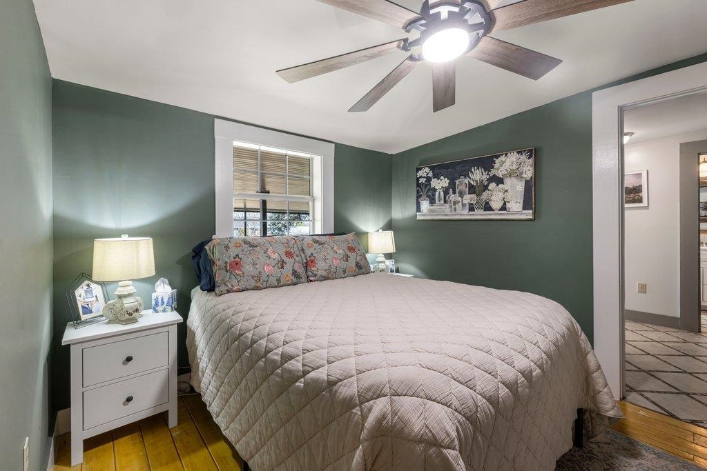 403 West Main Street Llano, TX 78643 - Photo 11 of 28 a bedroom with a bed and a chandelier