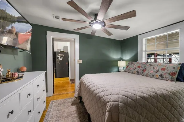 a bedroom with a bed and a chandelier