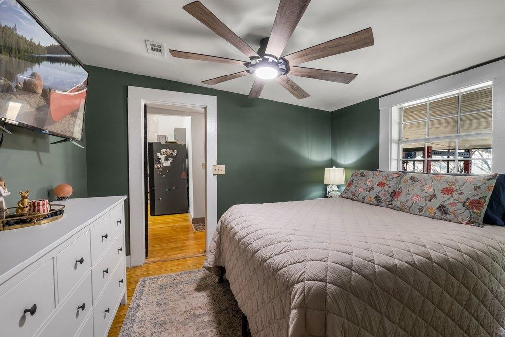 403 West Main Street Llano, TX 78643 - Photo 12 of 28 a bedroom with a bed and a chandelier