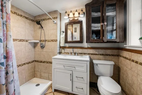 a bathroom with a toilet sink and shower