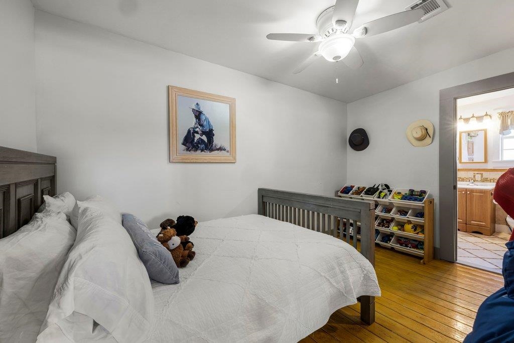 403 West Main Street Llano, TX 78643 - Photo 15 of 28 a bedroom with a bed and wooden floor