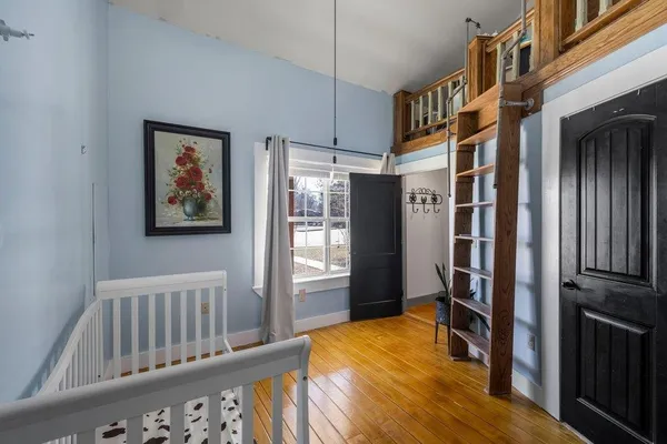 a view of an entryway with wooden floor