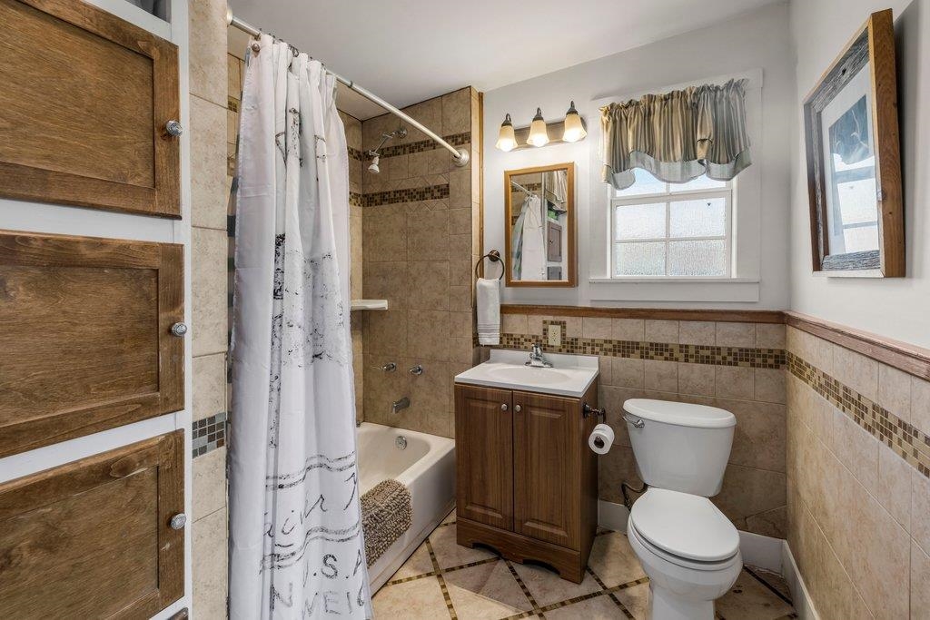 403 West Main Street Llano, TX 78643 - Photo 18 of 28 a bathroom with a granite countertop toilet sink and shower
