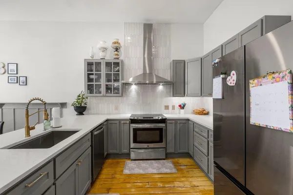 a kitchen with stainless steel appliances granite countertop a sink stove and refrigerator