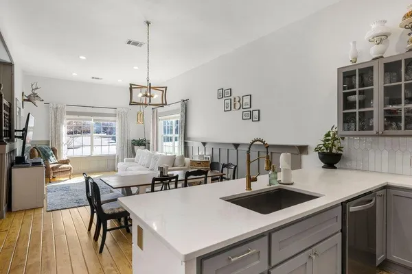 a kitchen with a sink a stove and chairs
