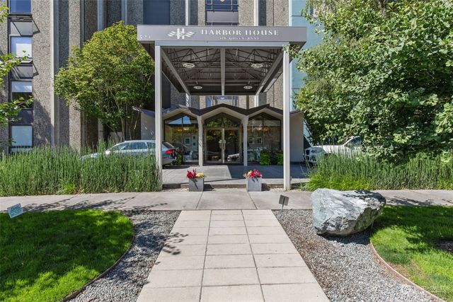 a view of a patio with table and chairs potted plants and a large tree
