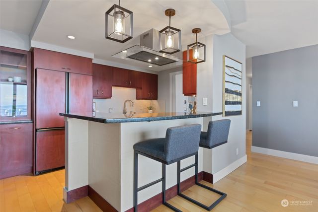 a kitchen with cabinets a stove and a wooden floor