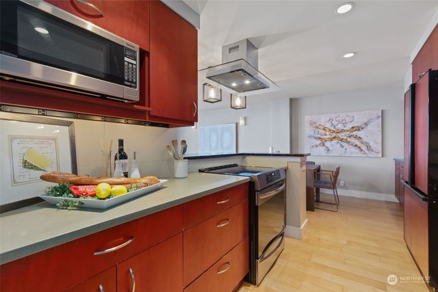 a kitchen with stainless steel appliances granite countertop a sink and a stove