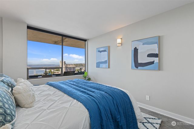 a bedroom with a large bed and a large window