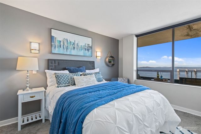 a bedroom with a bed and a night stand