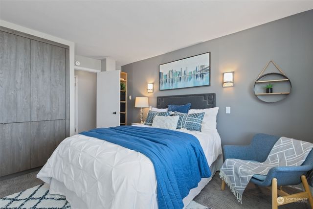 a bed room with a bed and chair