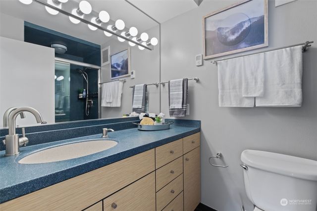 a bathroom with double vanity sink a mirror and vanity