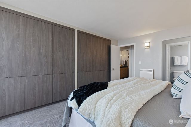 a bedroom with a bed and a cabinet