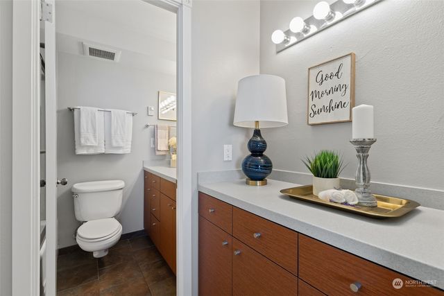 a view of bathroom with a toilet sink and mirror