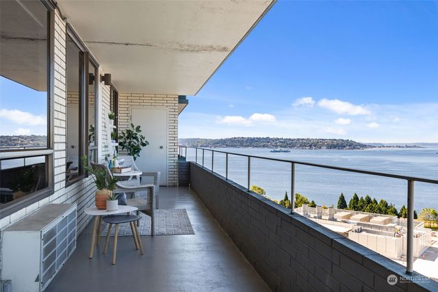 a balcony with furniture and a potted plant