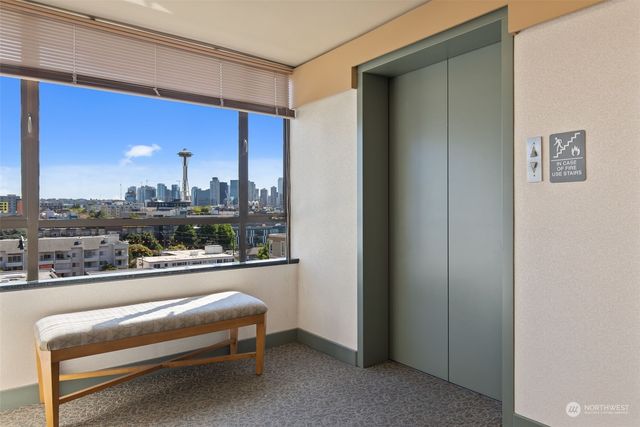a living room with furniture a city view and a large window