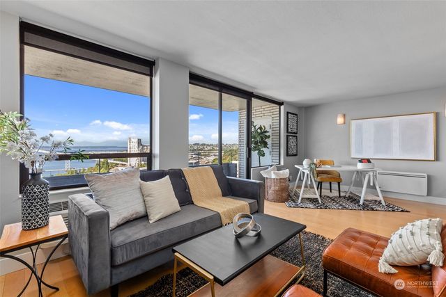 a living room with furniture and a large window